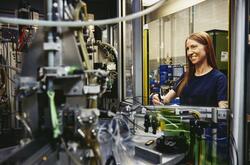 Woman operating a machine on a production site. 