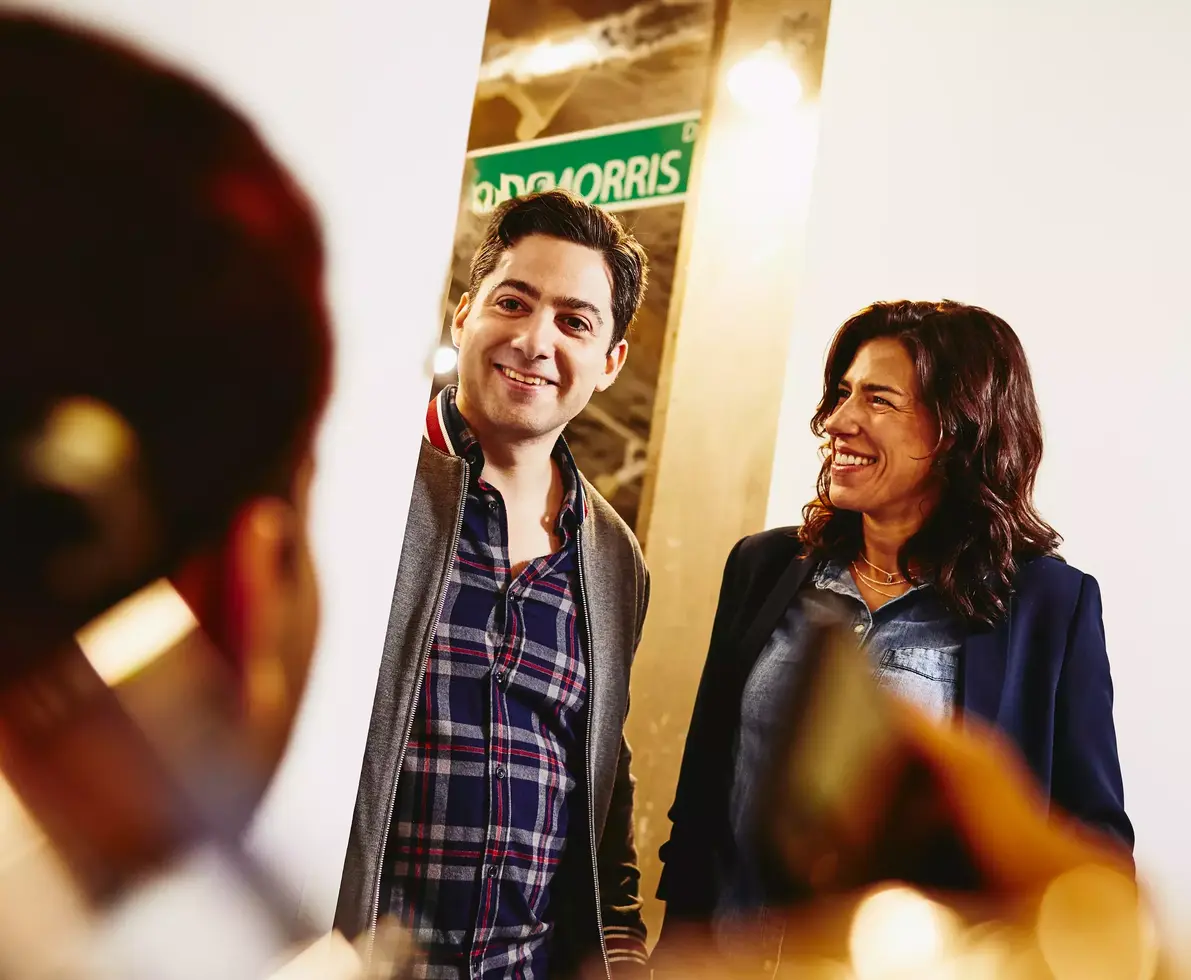 Group having a conversation. Smiling. Office setting.
